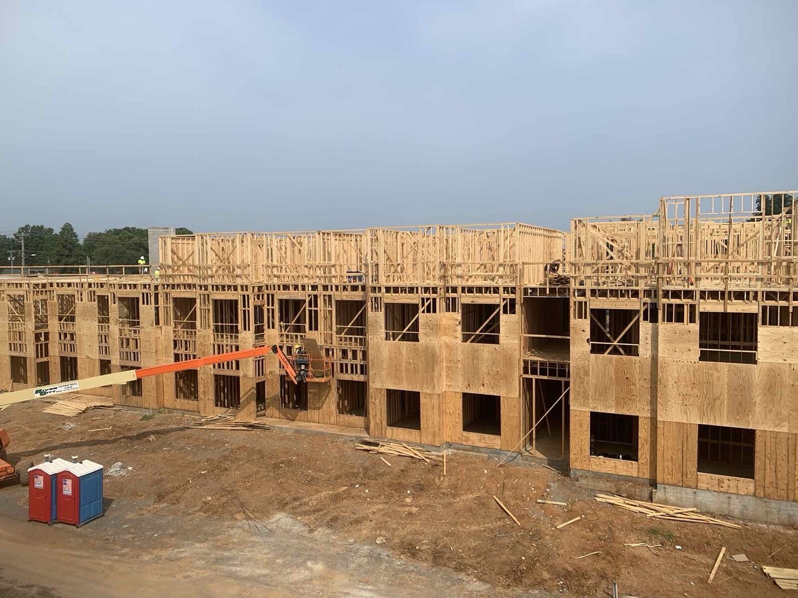 Row of multi-family buildings in active wood-frame construction